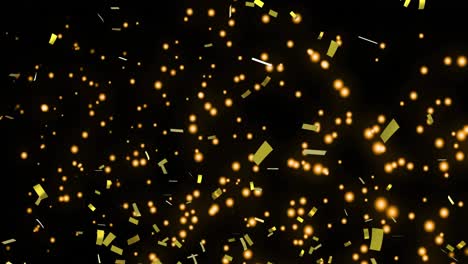 Golden-confetti-and-glowing-spots-moving-against-black-background