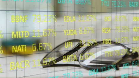 Stock-market-data-processing-against-glasses-lying-on-a-table