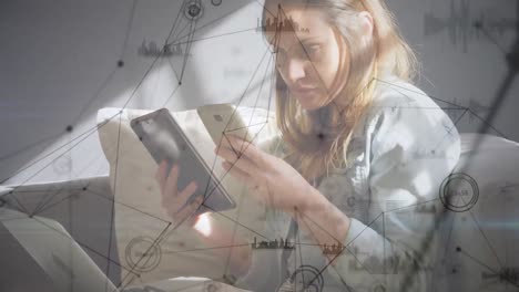 Web-of-connections-against-woman-using-digital-tablet-and-smartphone