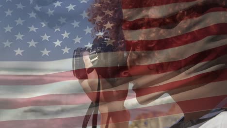 Animation-Einer-Amerikanischen-Flagge,-Die-über-Einer-Frau-Mit-Gemischter-Rasse-Schwenkt,-Die-Mit-Der-Kamera-Am-Strand-Fotografiert