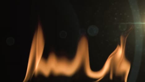 Animation-of-flames-burning-in-slow-motion-with-glowing-spots-of-lights-moving-on-black-background
