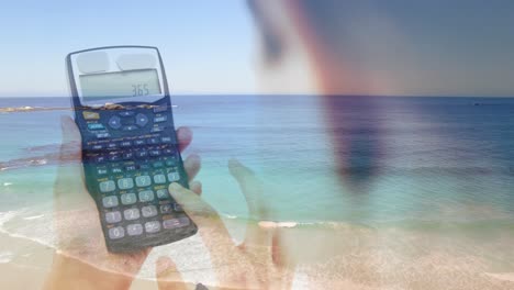 Animation-of-Caucasian-woman-using-a-calculator-over-an-aerial-view-of-a-beach