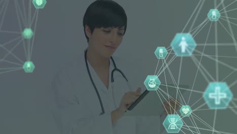 Globe-of-digital-icons-against-doctor-using-digital-tablet