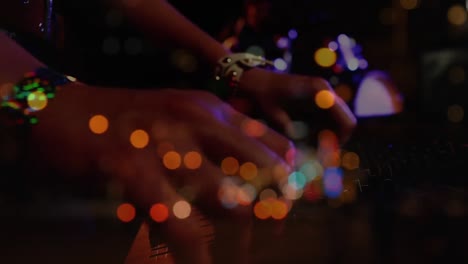 Glowing-spots-of-lights-against-woman-DJing