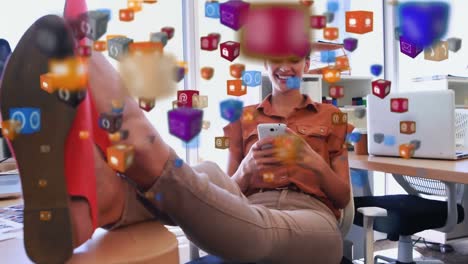 Digital-icons-floating-against-woman-using-smartphone-at-office