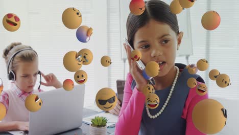 Multiple-face-emojis-floating-against-girl-talking-on-smartphone