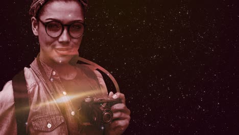 Space-over-woman-with-digital-camera-against-stars-shining-in-background