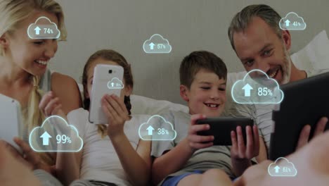 Multiple-cloud-icon-with-increasing-percentage-against-family-using-electronic-devices-in-bed