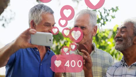 Heart-icons-with-increasing-numbers-against-three-senior-man-taking-a-selfie