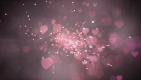 Heart-shaped-light-sparks-against-pink-background