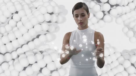 woman-using-transparent-interactive-screen-over-pulsating-white-balls