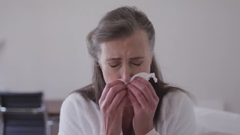 Sick-woman-with-tissue-sneezing-at-home