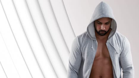 bare-chest-man-in-hooded-top-over-pulsating-white-shapes