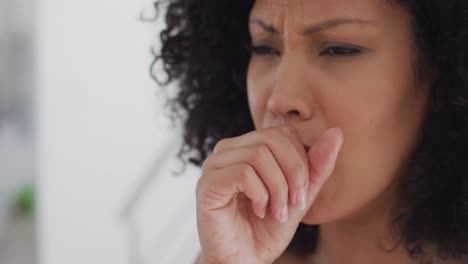 Close-up-view-of-woman-coughing-at-home