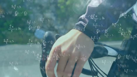 Mathematical-equations-against-person-holding-handlebars-of-the-cycle
