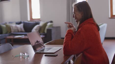 Woman-having-a-video-chat-on-her-laptop-at-home