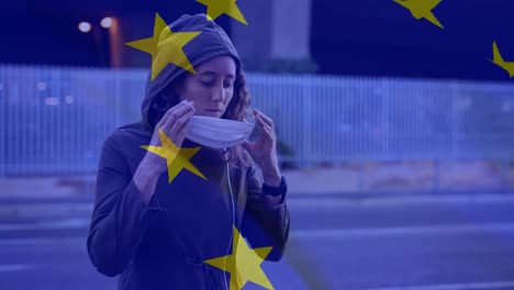 EU-flag-waving-against-woman-wearing-face-mask