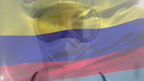 Colombian-flag-waving-against-female-scientist-wearing-protective-clothes