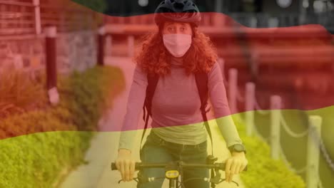 Deutsche-Flagge-Weht-Gegen-Frau-Mit-Gesichtsmaske,-Die-Fahrrad-Fährt
