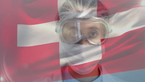Swiss-flag-waving-against-female-doctor-wearing-face-mask