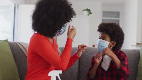 Mother-putting-face-mask-on-her-son-at-home