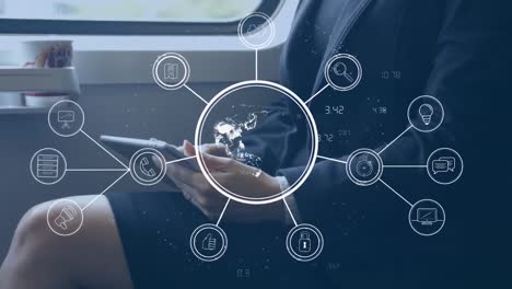 Network-of-connection-icons-against-mid-section-of-woman-using-digital-tablet-in-train