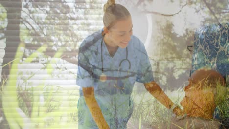 Female-health-worker-talking-to-male-patient-against-grass-waving-in-background