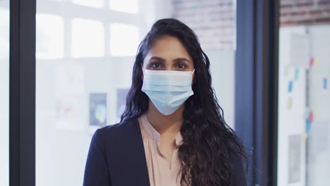 Portrait-of-woman-wearing-face-mask-at-office