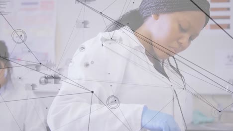 Network-of-connections-and-data-processing-against-two-female-scientists-working-in-laboratory