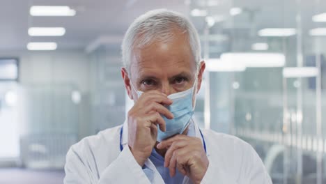 Portrait-of-male-doctor-wearing-face-mask-in-hospital