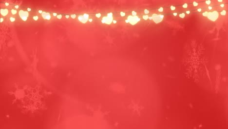 Snowflakes-falling-over-glowing-fairy-lights-red-background