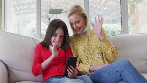 Mother-and-daughter-having-a-video-chat-on-smartphone-at-home
