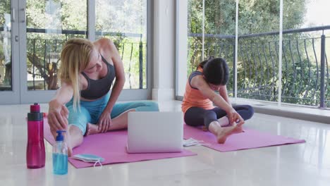 Mother-and-daughter-performing-stretching-exercise-at-home