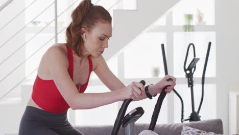 Woman-exercising-on-stationary-bike-at-home