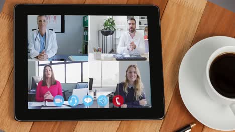 Digital-interface-with-icons-on-digital-tablet-screen-with-people-talking-on-video-call