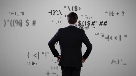 Rear-view-of-businessman-looking-at-mathematical-symbols-on-grey-background