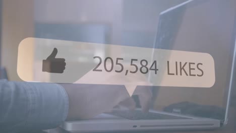Speech-bubble-with-thumbs-up-icon-and-increasing-numbers-against-person-using-laptop