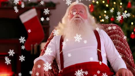 Snowflakes-falling-against-Santa-Claus-sleeping-on-a-chair