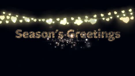 Seasons-Greetings-text-and-fairy-lights-against-fireworks-exploding-on-black-background