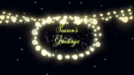 Seasons-Greetings-text-and-fairy-lights-against-glowing-spots-on-black-background