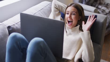 Woman-having-a-video-chat-on-her-laptop-at-home
