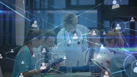 Digital-animation-of-blue-light-trails-and-network-of-connection-icons-against-group-of-medical-prof