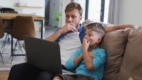 Caucasian-man-and-his-son-sitting-on-a-couch