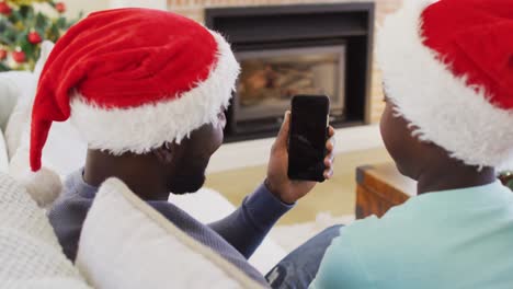 African-american-father-and-son-having-a-videocall-on-smartphone