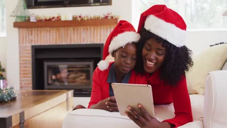African-american-mother-and-daughter-having-a-videocall-on-tablet