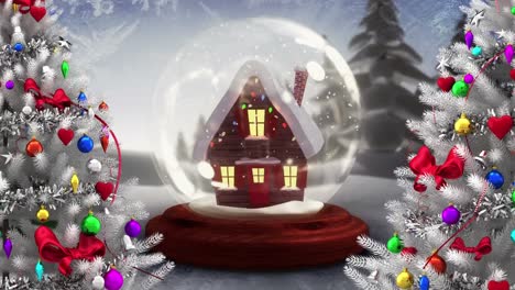 Digital-animation-of-two-christmas-trees-against-house-in-snow-globe-on-winter-landscape