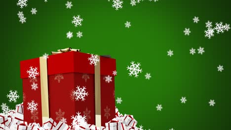 Digitale-Animation-Von-Schneeflocken,-Die-über-Eine-Weihnachtsgeschenkbox-Vor-Grünem-Hintergrund-Fallen