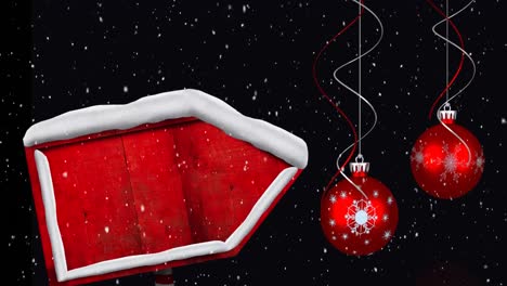 Digitale-Animation-Von-Schnee,-Der-über-Einen-Roten-Holzschildpfosten-Fällt-Und-Eine-Hängende-Weihnachtskugeldekoration