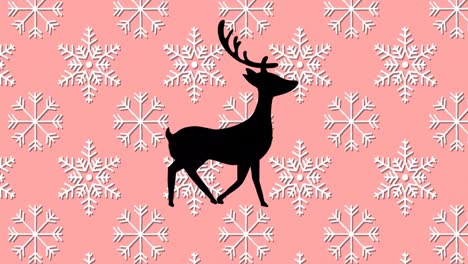Digital-animation-of-black-silhouette-of-reindeer-walking-against-snowflakes