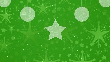 Digital-animation-of-snow-falling-over-christmas-star-and-bauble-decorations-against-green